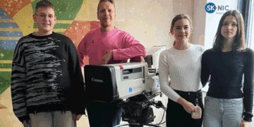 Učiteľ a deti pred bannerom s logom Fondu SK-NIC, Výzva pre malé projekty 2025